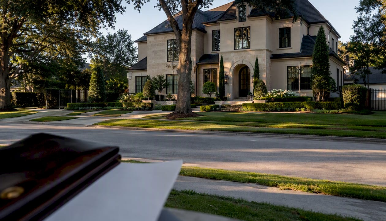 Luxury Houston home exterior with insurance documents