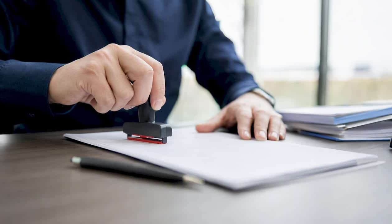 Hands stamping payoff release document