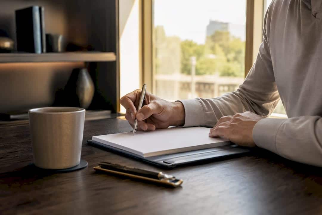 Hands reviewing contract paperwork in luxury home office