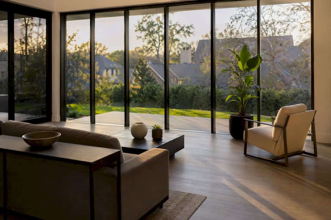 Modern living room with large floor-to-ceiling windows and natural light