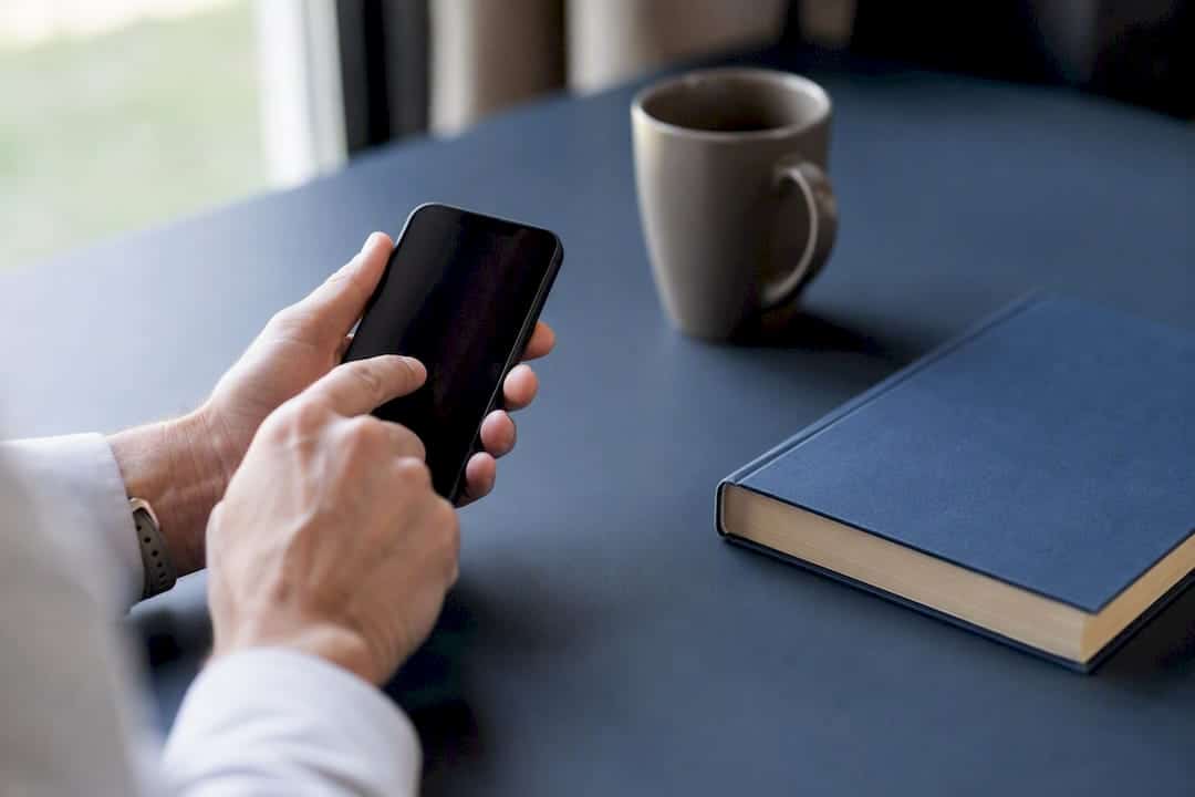 Hands dialing phone to contact agent reference