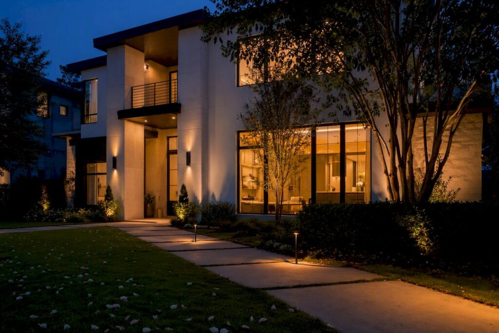 Luxury home exterior at twilight with warm interior lights