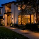 Luxury home exterior at twilight with warm interior lights