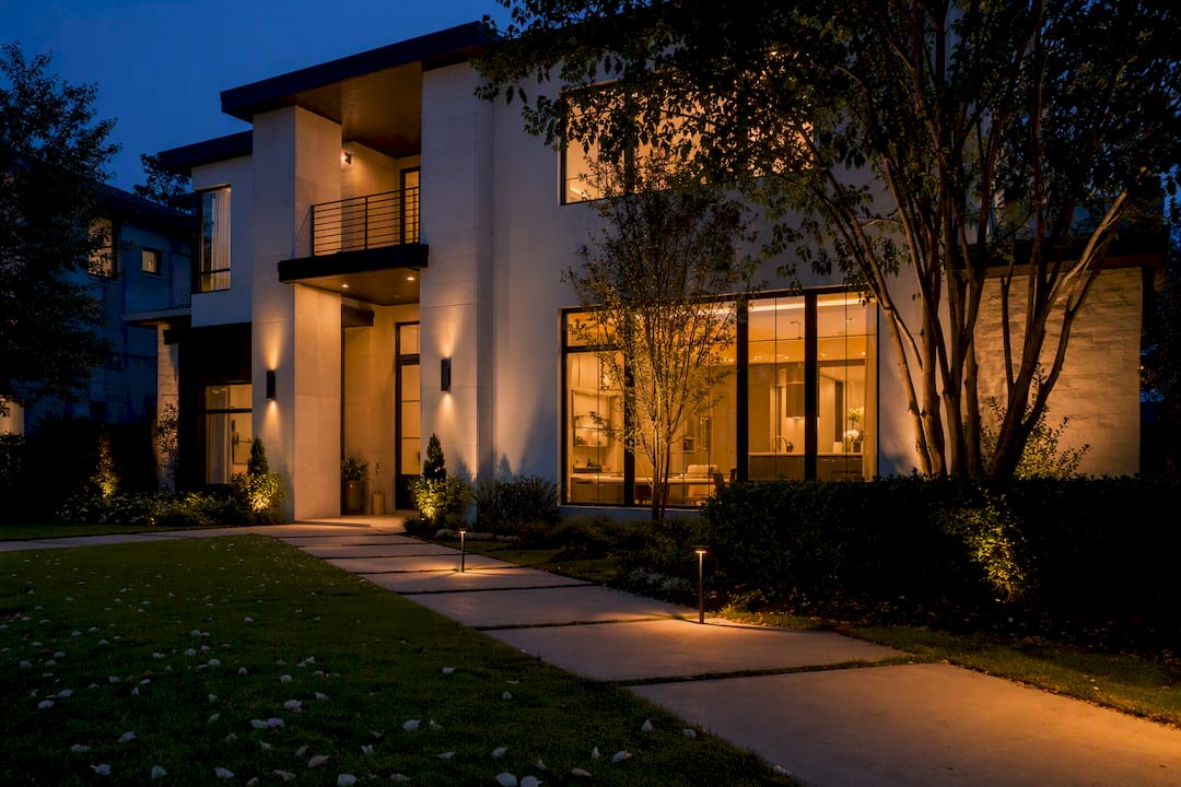 Luxury home exterior at twilight with warm interior lights