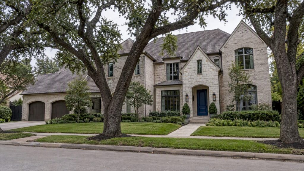 Luxury home beneath mature Houston oak trees